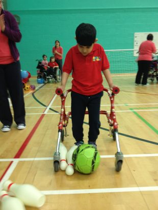 School boy playing Frame Football in PE lesson