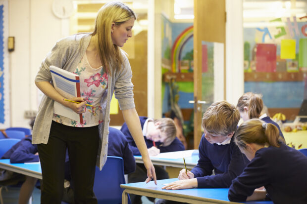 Teacher talking to pupils in classroom