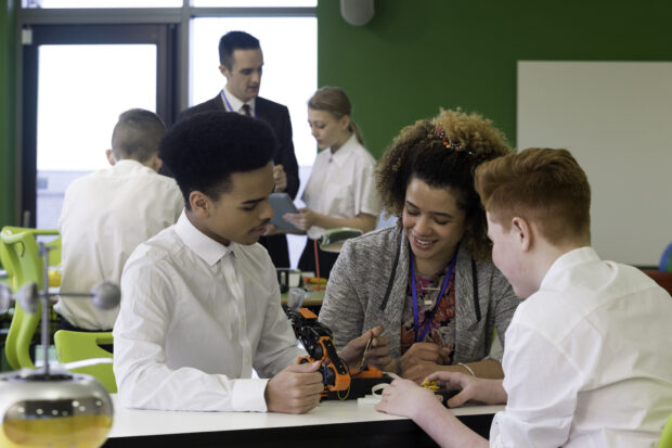 Teacher discussing work with pupils