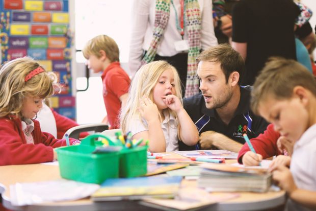 Male teacher with primary school pupils