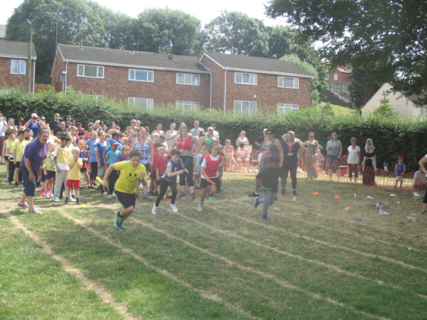 Primary school children sprinting in PE lesson