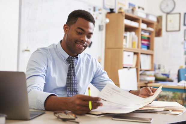 Young male teacher at his desk