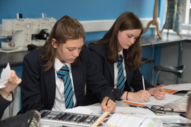 Two pupils working in class