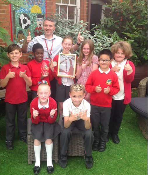 Pupils and the headteacher from Springfield Junior School posing with their Pupil Premium Award