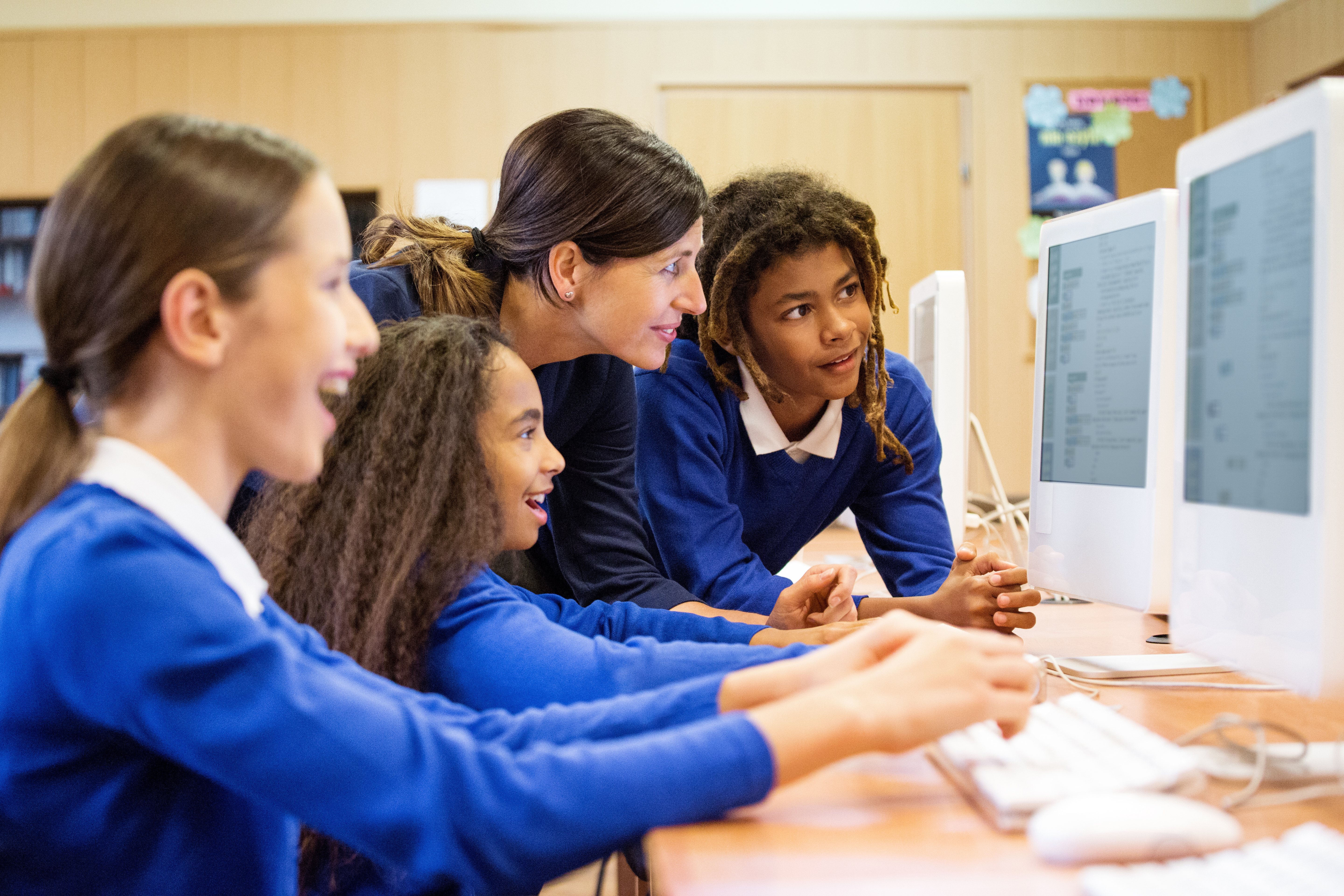 Teacher and pupils at a computer