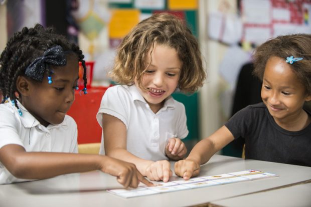 Three primary school children in classroom