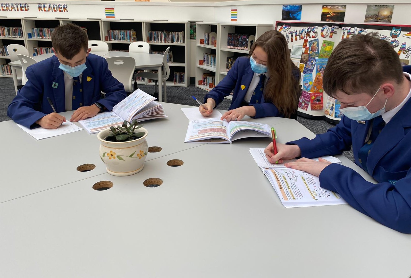 3 pupils working at desk wearing face coverings - Star Academies