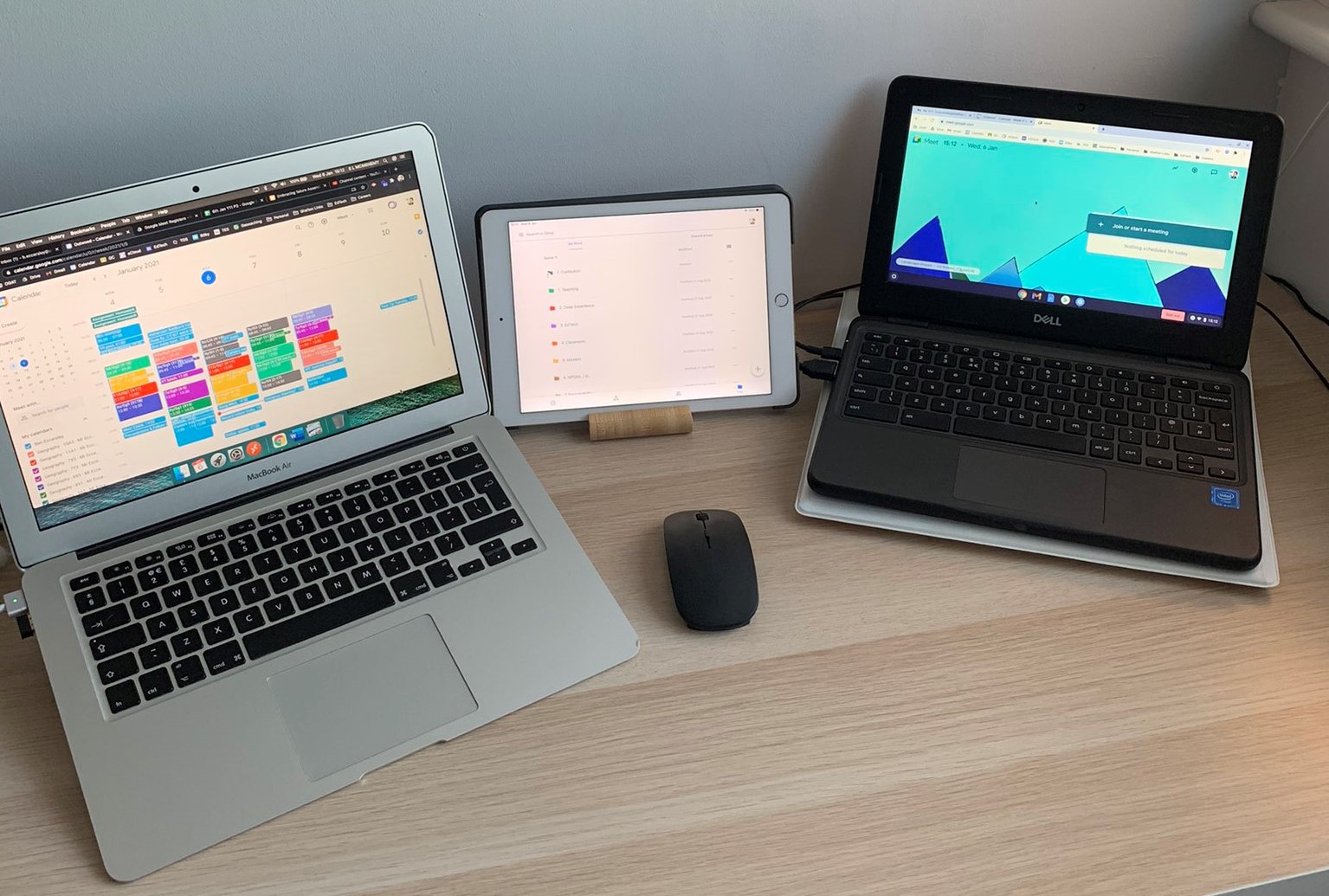 2 laptops and a tablet on a desk showing remote education planning