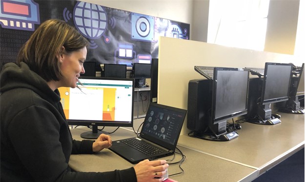 Karen Morris working on a laptop in a computer suite