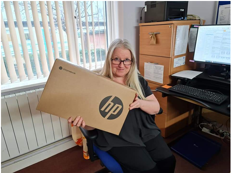 A blonde woman, Terri Wyse, with new laptop box