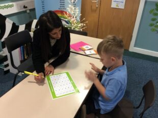 Academic mentor working with young boy