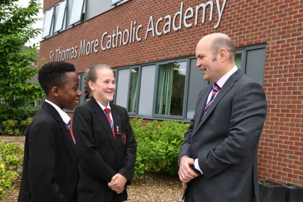 Students and a teacher in conversation outside St Thomas More Catholic Academy