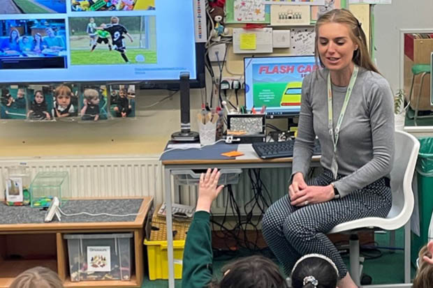 A teacher speaking to her class