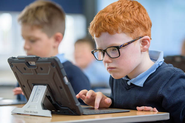 A pupil on his tablet.