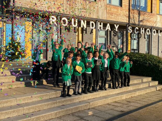 Children at Roundhay School cheering with confetti falling