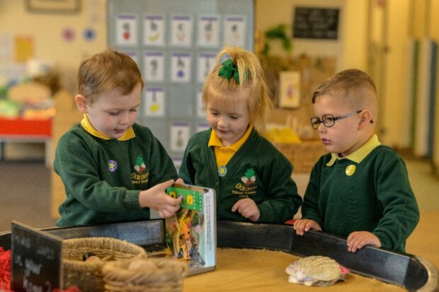 3 young pupils at school playing